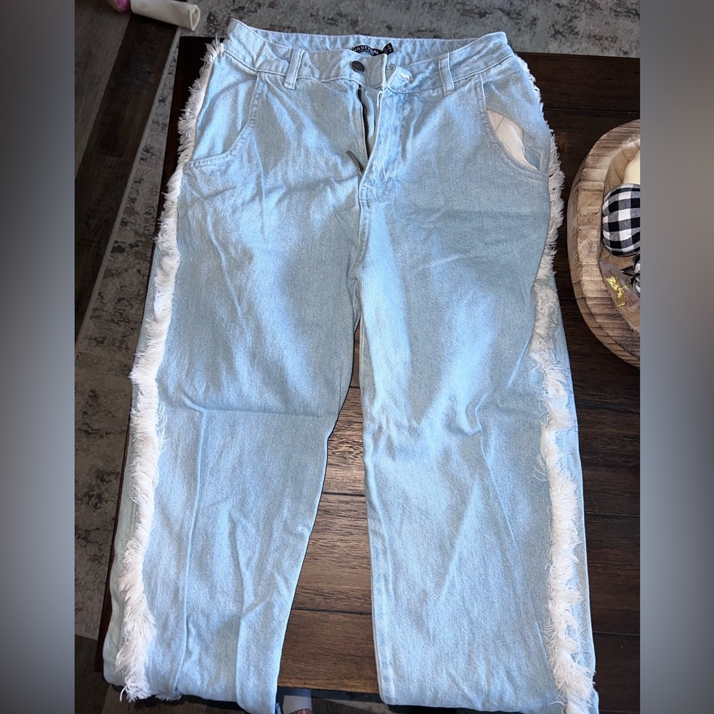 Blue jeans with white fringe on side